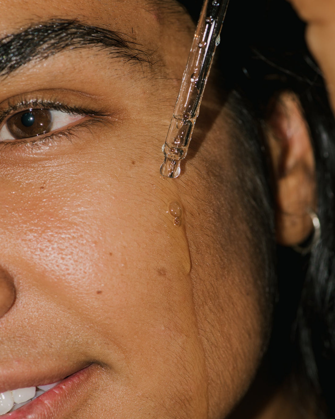 Close up of Compound K Hyaluronic Booster on face.
