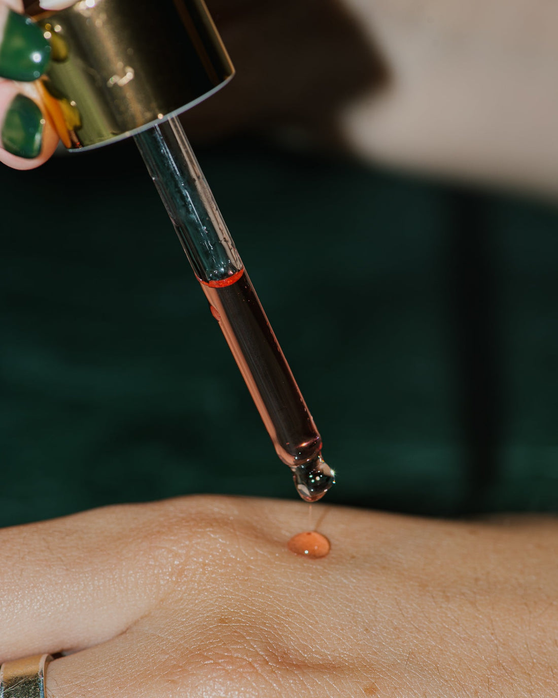 Close up of Advanced Red Oil Serum on skin.